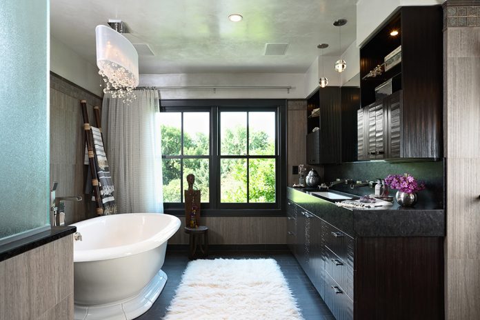 master bath and tub with dark wood cabinets