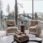 The Great Room in Sapphire Summit gives way to sweeping views of snowy mountains.