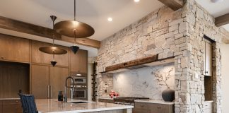 Mountain Living Redefined: A Buyer’s Guide The kitchen in Sapphire Summit features wood from floor to ceiling, including reclaimed wood beams from Manomin Resawn Timbers.