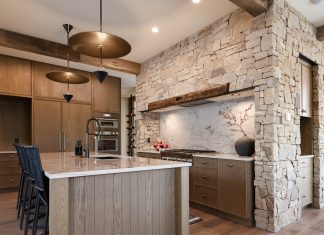 Mountain Living Redefined: A Buyer’s Guide The kitchen in Sapphire Summit features wood from floor to ceiling, including reclaimed wood beams from Manomin Resawn Timbers.