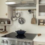 Trend Forecast 2026, Interiors: Comfort Colors and Cottagecore Charm A cottage-style kitchen with thoughtful detailing and floating shelves from Revival House.