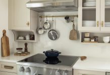 Trend Forecast 2026, Interiors: Comfort Colors and Cottagecore Charm A cottage-style kitchen with thoughtful detailing and floating shelves from Revival House.
