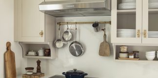 Trend Forecast 2026, Interiors: Comfort Colors and Cottagecore Charm A cottage-style kitchen with thoughtful detailing and floating shelves from Revival House.