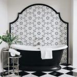 Trend Forecast 2026, Kitchen + Bath: Pattern Play and Cabinetry Crazes A bathroom with elegant tiling details, in bold black and white