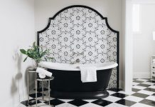 A bathroom with elegant tiling details, in bold black and white