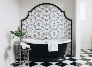Trend Forecast 2026, Kitchen + Bath: Pattern Play and Cabinetry Crazes A bathroom with elegant tiling details, in bold black and white