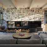 5 Minnesota Fireplaces That Take Cozy to the Next Level This wood-burning fireplace in a Cross Lake home is surrounded by a horizontal, built-in blackened steel framework and stone.