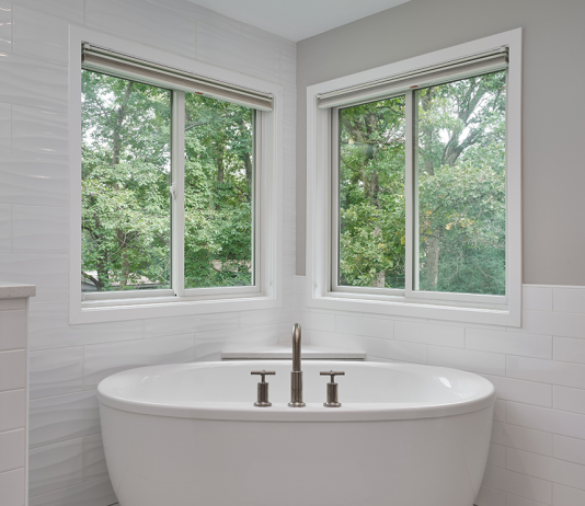 open-concept-shower-and-large-white-soaking-tub-in-corner-of-windows
