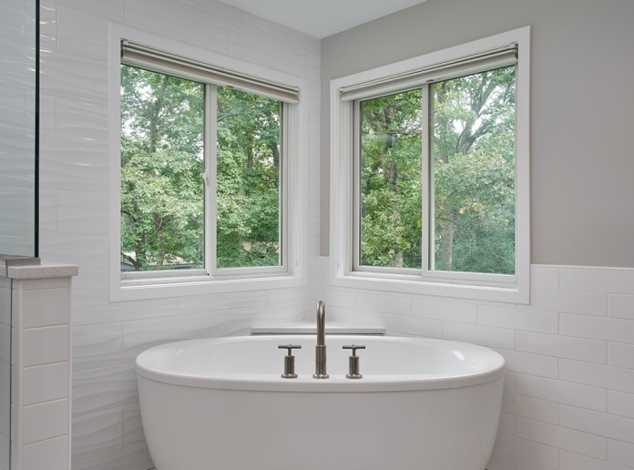 open-concept-shower-and-large-white-soaking-tub-in-corner-of-windows