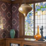 Artistic Glass Window Adds Warmth and Personality to This Historic Home Inspiration for the design of the glass in this room came from the client’s favorite flower—a clematis vine that blooms in the homeowner's yard.