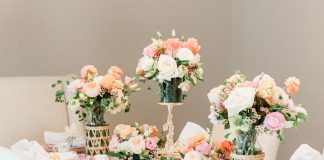 Varying heights and vessels add visual interest to floral arrangements at the dining table