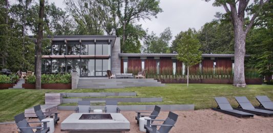 Lakeside Living: Cascading Terraces Reimagine Backyard Deck Design Casacading terraces create distinct zones for outdoor enjoyment paired with lake views.