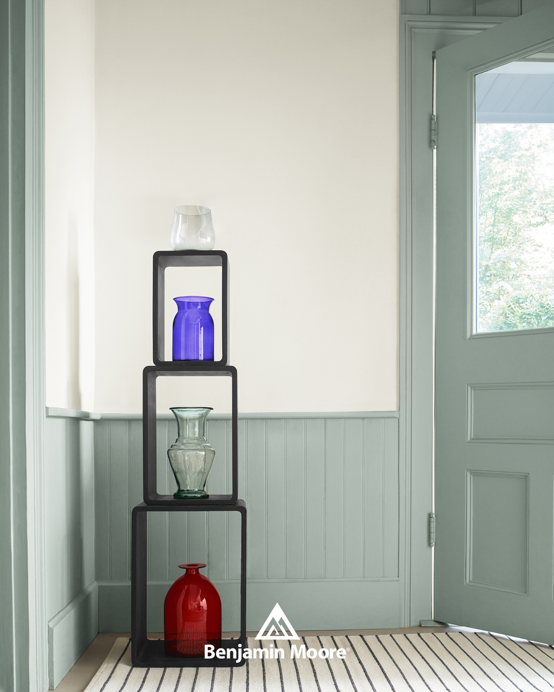Restorative greens, like Raindance from Benjamin Moore, are on the rise. Pops of color from decor, like these vases, can add visual interest to a room without overwhelm.