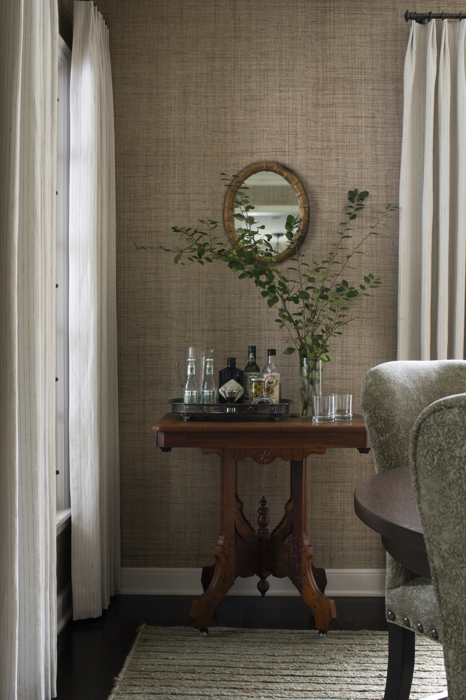 In this 1940s Colonial home in Edina, the table in the dining room that now serves as a bar was previously underutilized in a corner of the bedroom.