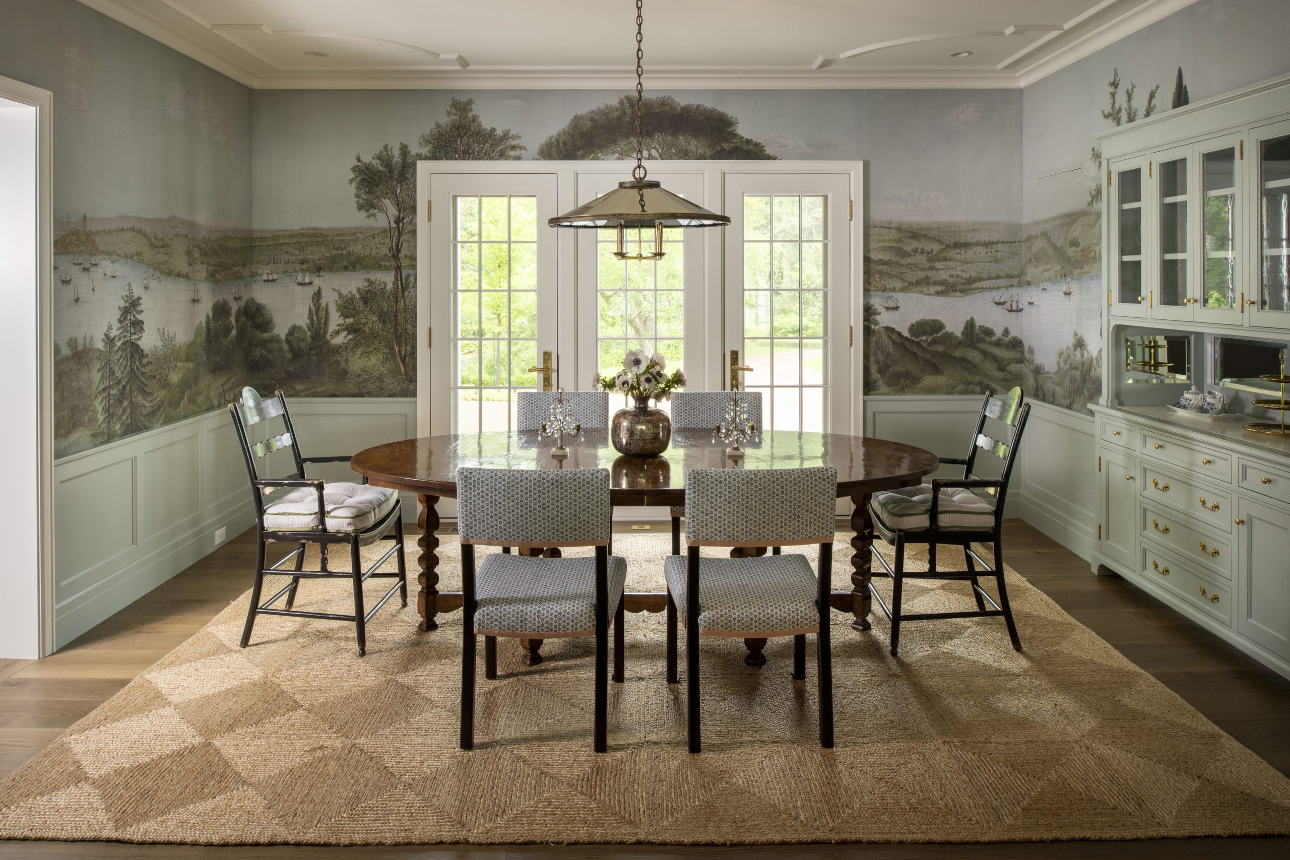 A hand-painted wall covering depicting a Turkish waterway sets a subtle, yet dramatic tone in this dining room from Rehkamp Larson Architects, Streeter Custom Builders, and Harris Weldon Interiors.