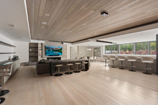 The lower level is built for entertaining, featuring a kitchenette, multiple TVs, and a sound system ideal for sports or movie nights. Guest suites with ensuite bathrooms on the same level make hosting family and friends easy.