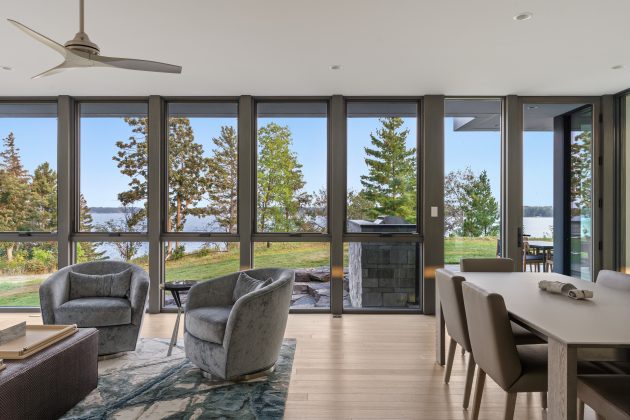 One of the homeowners&rsquo; favorite spaces in the house is the four-season porch. Enveloped by large triple-pane windows that open up in summer and keep the room cozy in winter, the room gives way to views of the lake and surrounding woods, creating a true year-round respite.