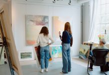 Sales + Events: May Is For Foodies, Green Thumbs, and Creatives Visitors select paintings for sale at an Art-A-Whirl artist studio