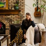 Lidia Valdivia Transforms Homes into Colorful Places of Refuge Lidia Valdivia sits in her newly remodeled living room, where raised the previously sunken space and added terracotta floors, and skylights and wood beams to the ceiling, creating an open, inviting atmosphere. Neutral Roman Clay walls allow artwork—some from her travels and home in Nicaragua, some created by her partner—to shine.