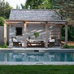 5 Pools for Prime for Summertime This charming backyard features a serene pool, hot tub, casual dining space, and an accessory building for storing equipment and supplies.
