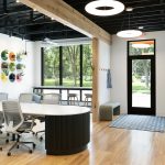 Inside a Custom Home Design and Build Firm’s Office Remodel Custom-designed metal shelves blend color, depth, and functionality.