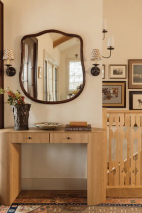 Upon entry, the home is awash in creamy colors and light wood. The custom stair balusters are a focal point, inspired by Scandinavian folklore motifs.