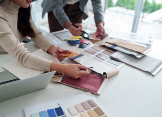 Interior designer team working with fabric sample, color palette for home renovation project. Architect choosing material for building design. Collaboration on modern decor ideas