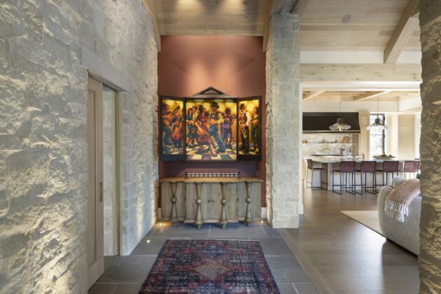 Inside, the entryway is anchored by a vibrant work of art from the homeowners&rsquo; collection.