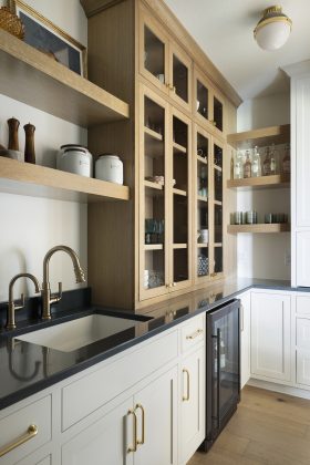 Butler's pantries don't need spacious footprints, like this one tucked behind the kitchen with an open archway