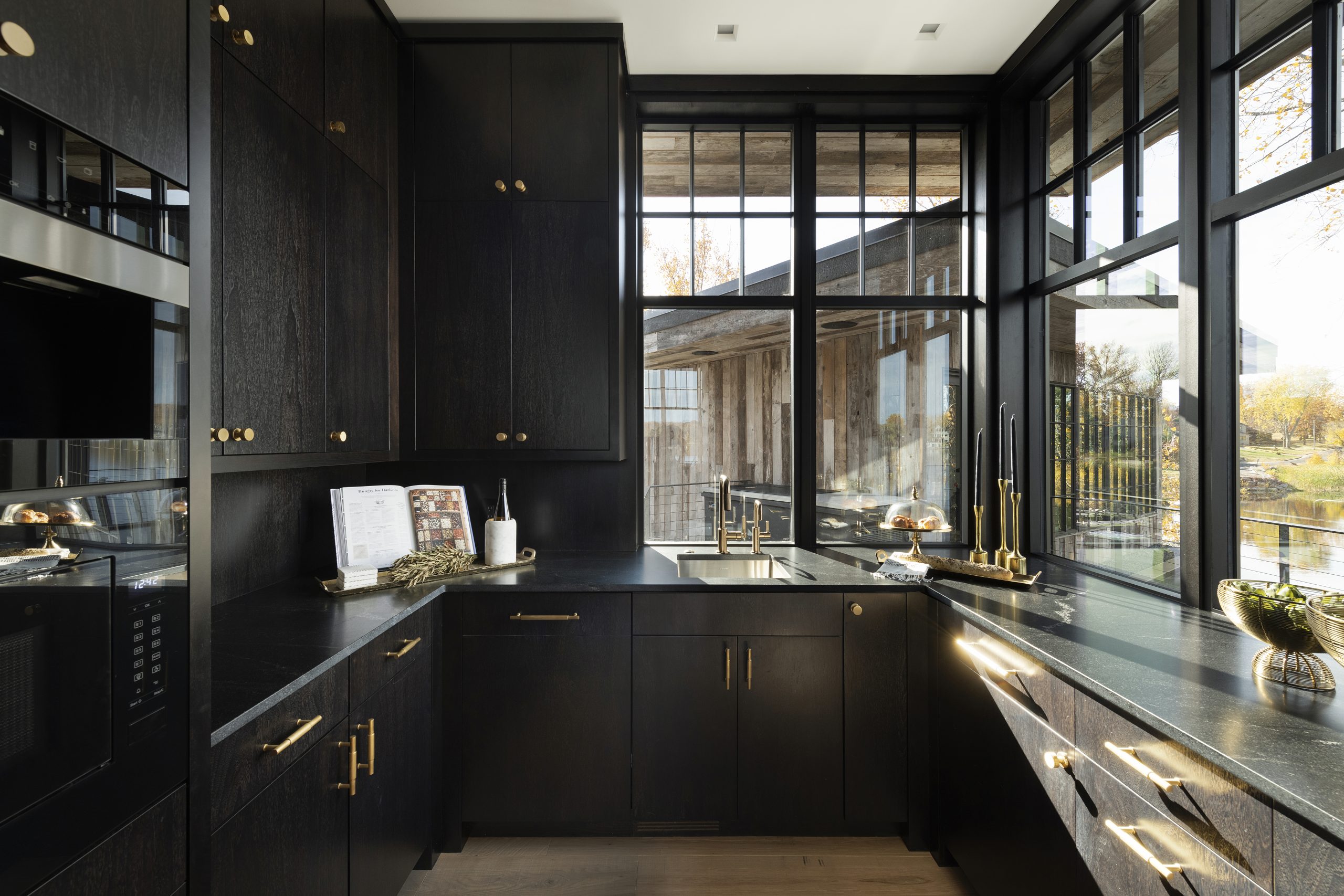 Natural pours into this butler's pantry to balance the dark cabinetry
