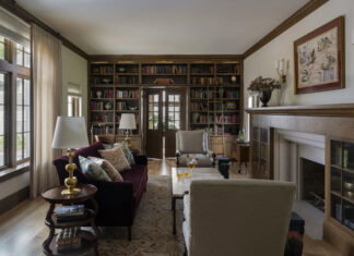 Home library with doors at the back that lead into an office space