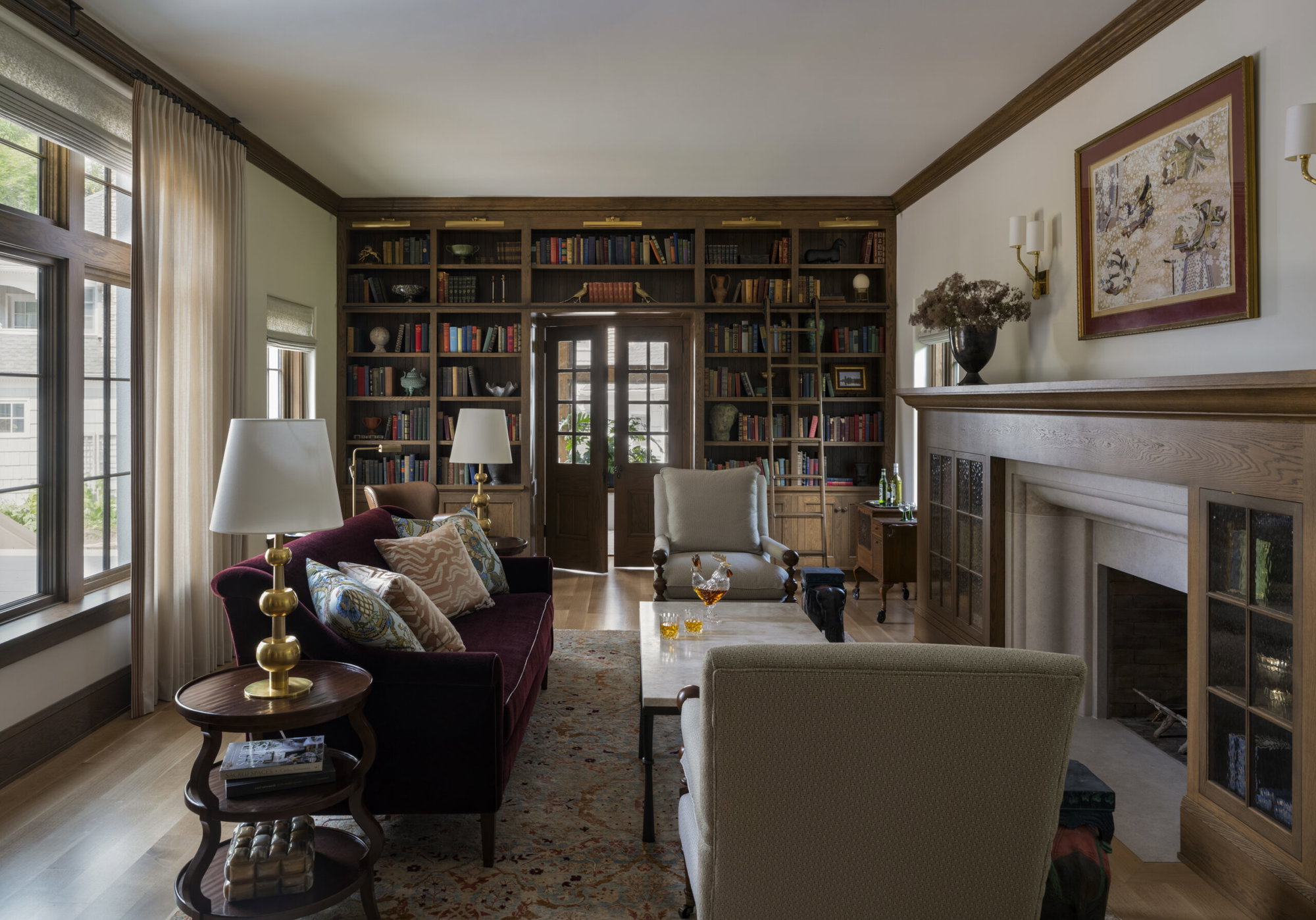Home library with doors at the back that lead into an office space