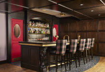 This Remodel Transforms a Basement Into a Stylish Home Pub Plaid upholstery complements brass hardware and rich wood, evoking images of faraway European pubs.